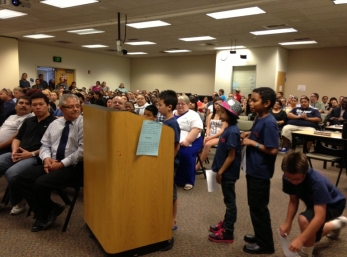 Students wait to present as Aidan takes his turn.
