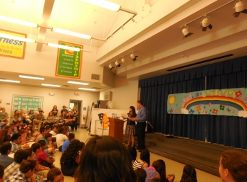 David addresses parents and students at 4th grade awards assembly.